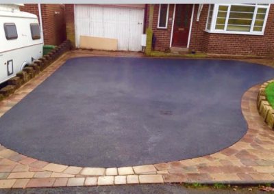 Block paving border with dark tarmac