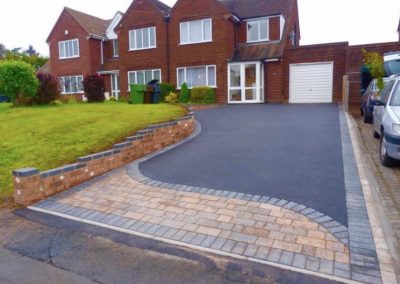 Block paving pattern with tarmac driveway