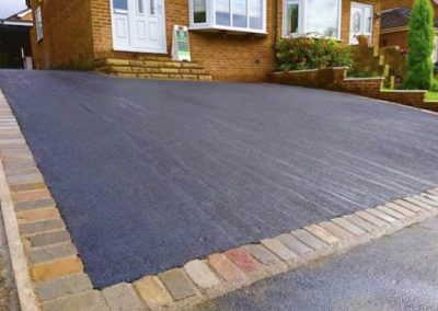 Dark tarmac driveway with border