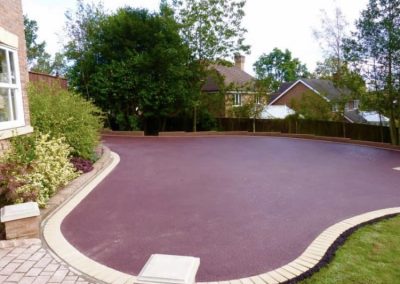 Red tarmac driveway with brick edging