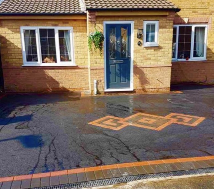 Patterned block paving with tarmac driveway